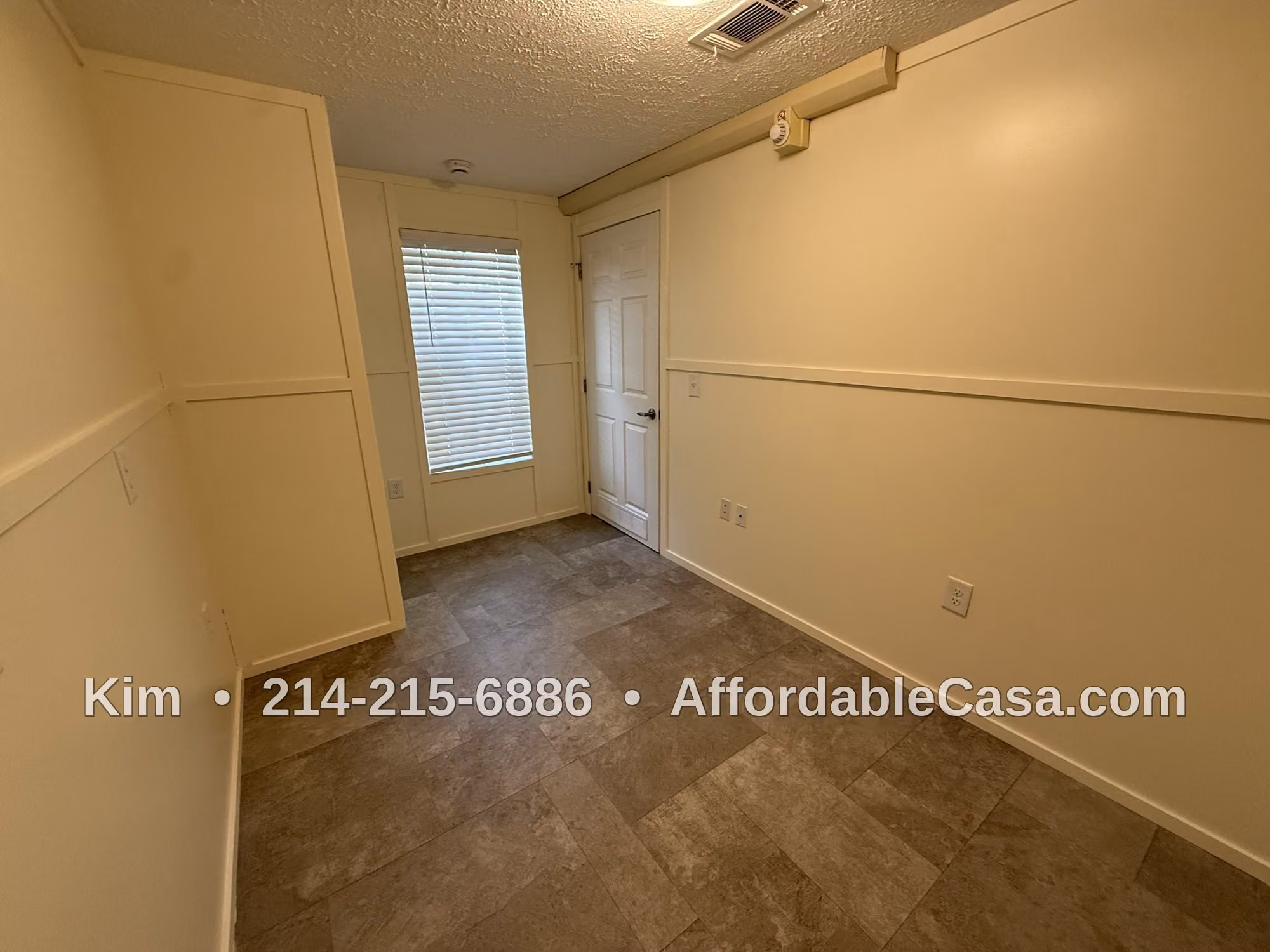 Empty room with a door and interior lighting. Text says "Kim, 214-215-6886, AffordableCasa.com".